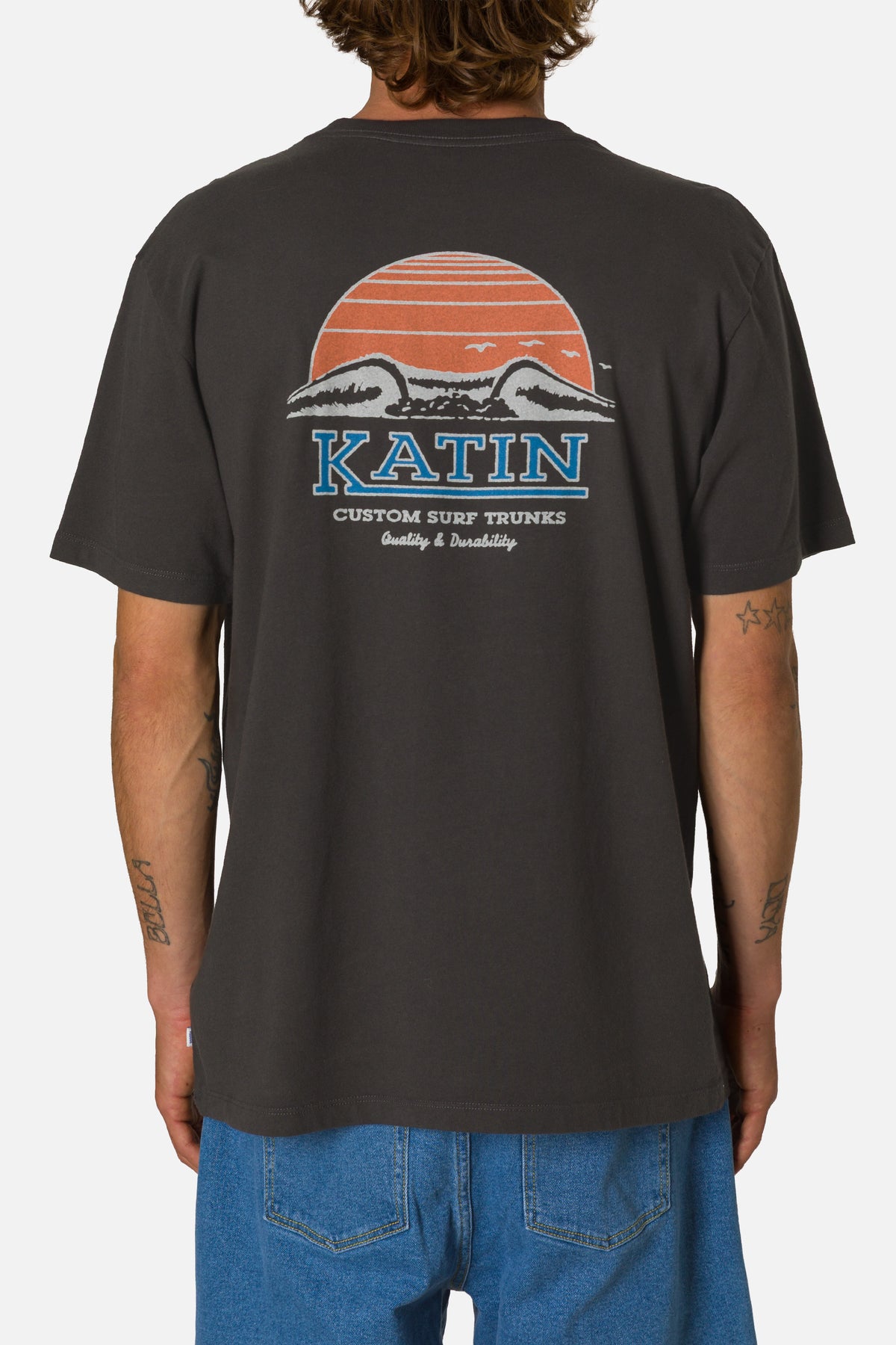 Person wearing a black t-shirt with a colorful graphic and 'Katin' branding on the back.