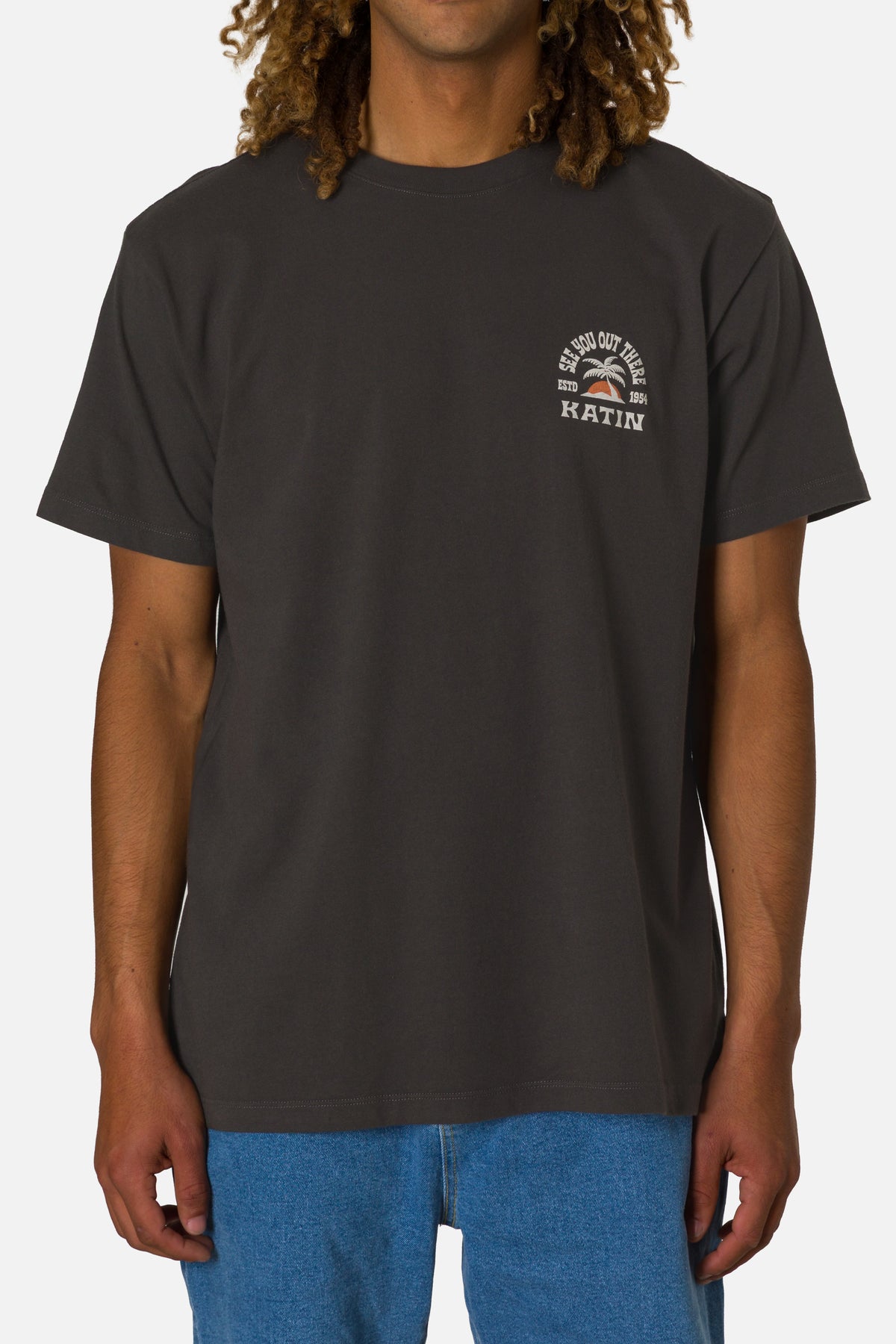 Person wearing a black t-shirt with a logo on a white background