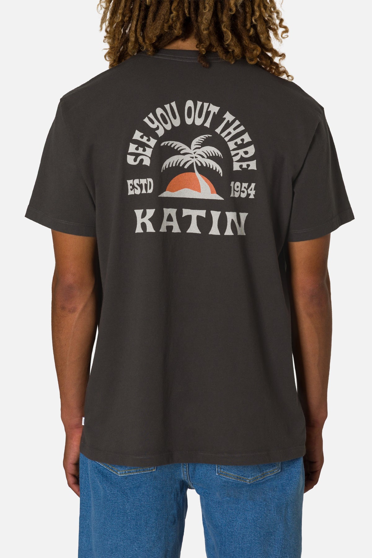 Person wearing a black t-shirt with 'Katin' branding and design on the back.