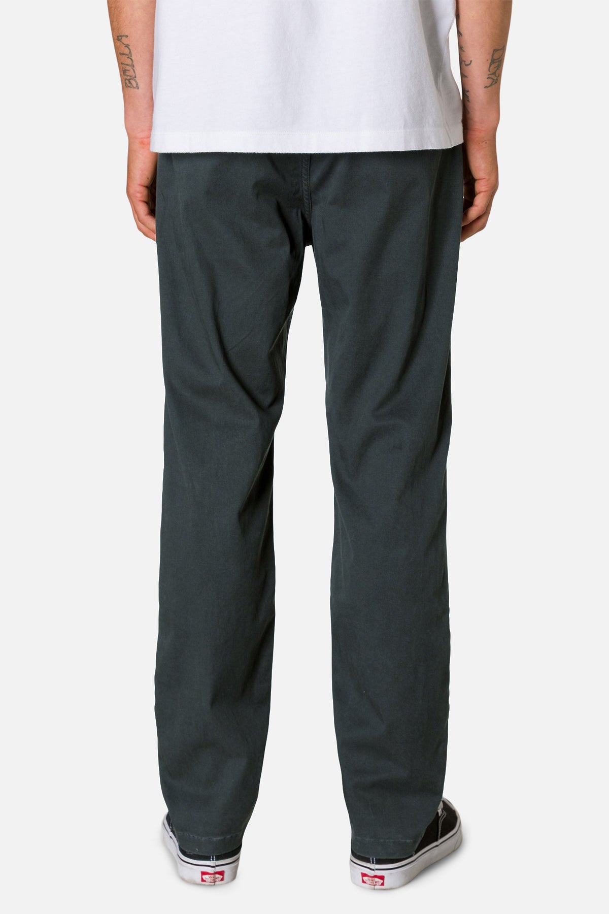 Person wearing dark gray pants and a white shirt on a white background