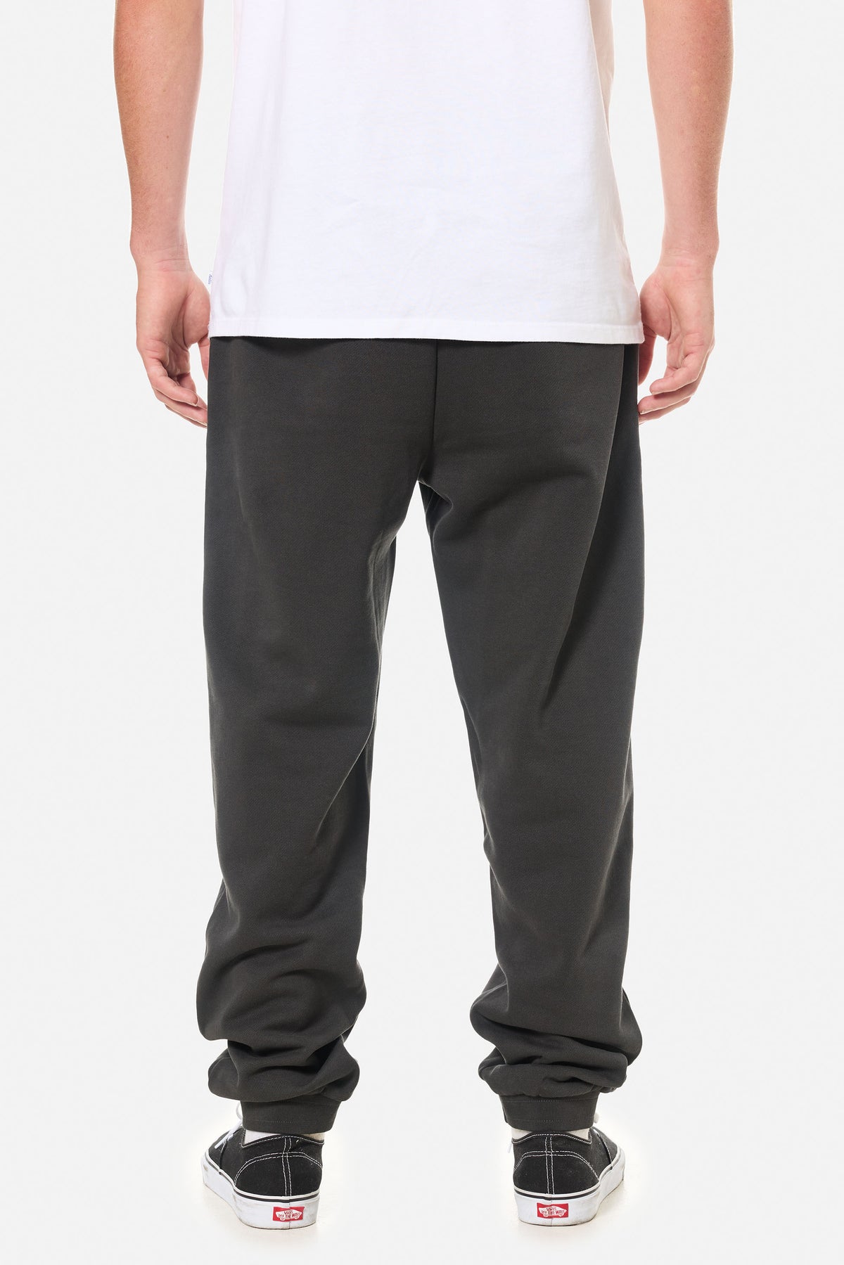 back of person wearing black wash lounge pants on a white background