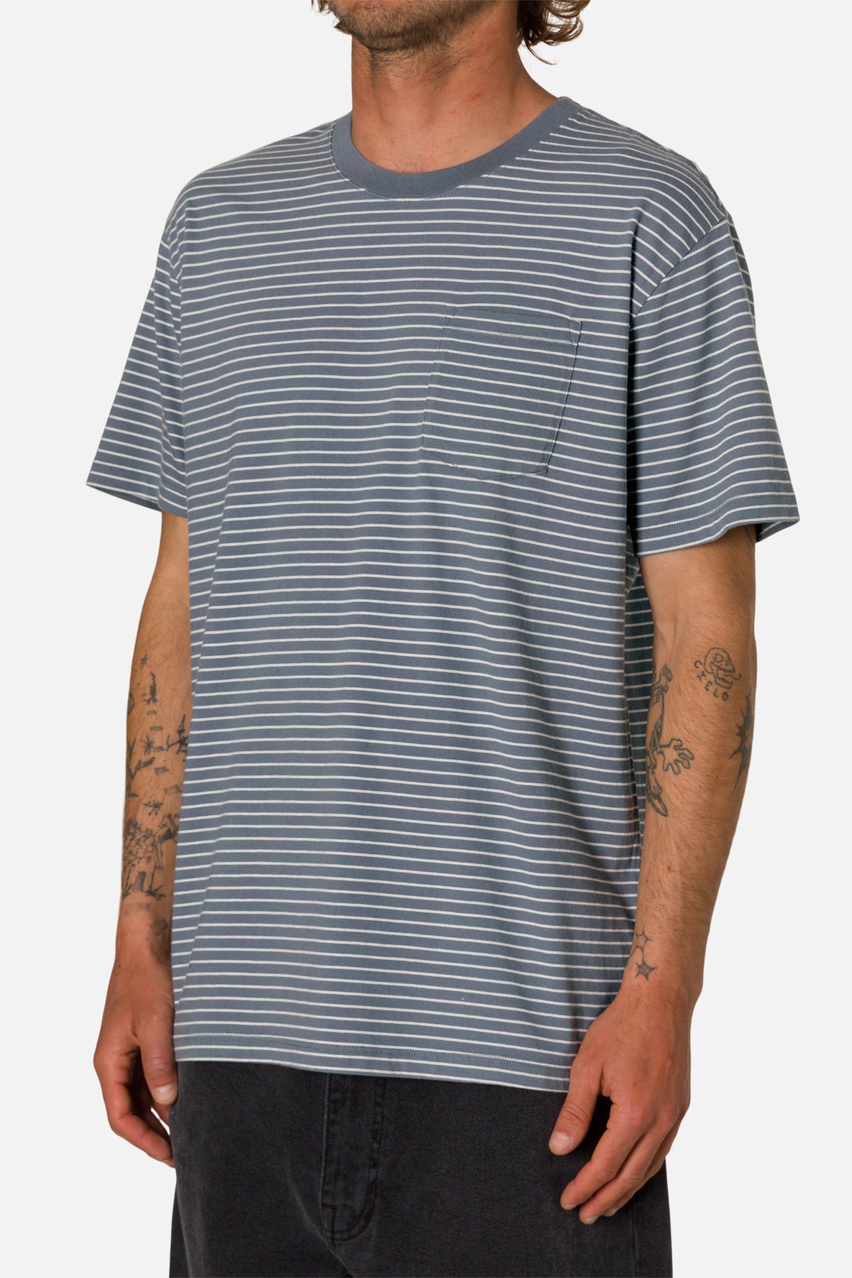Person wearing a gray and white striped t-shirt on a plain background