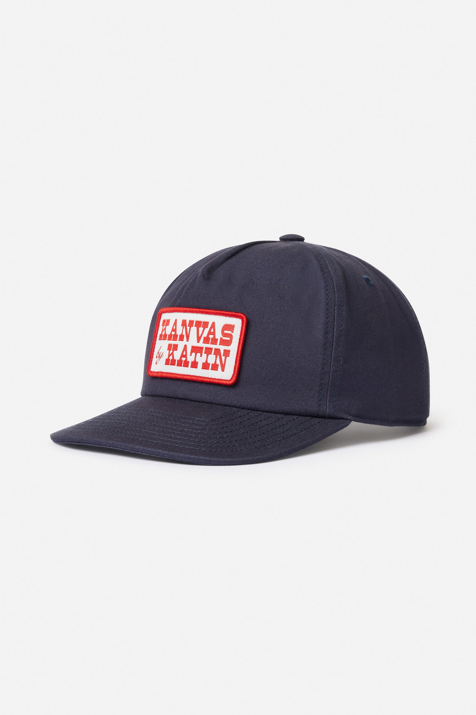 Navy blue cap with a red and white logo patch on a light gray background