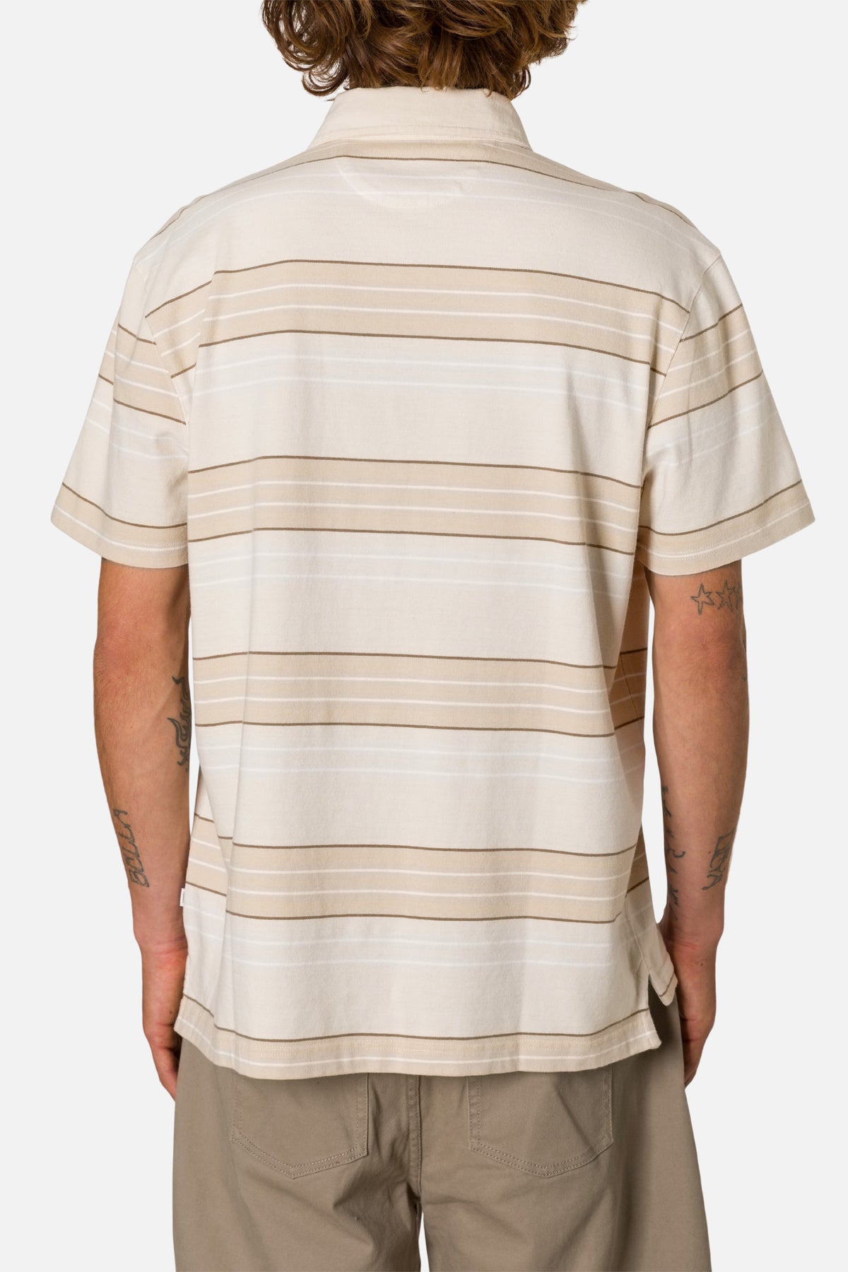 Person wearing a beige and white striped Polo shirt on a plain background