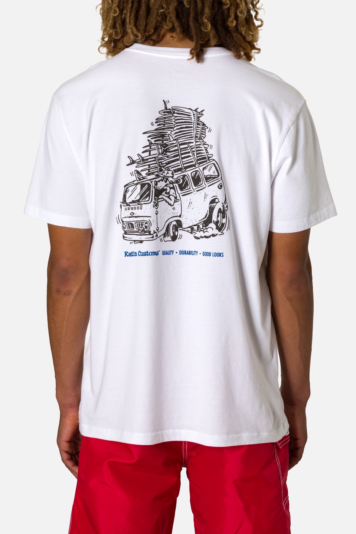 Person wearing a white t-shirt with a graphic design on the back, standing against a plain background.