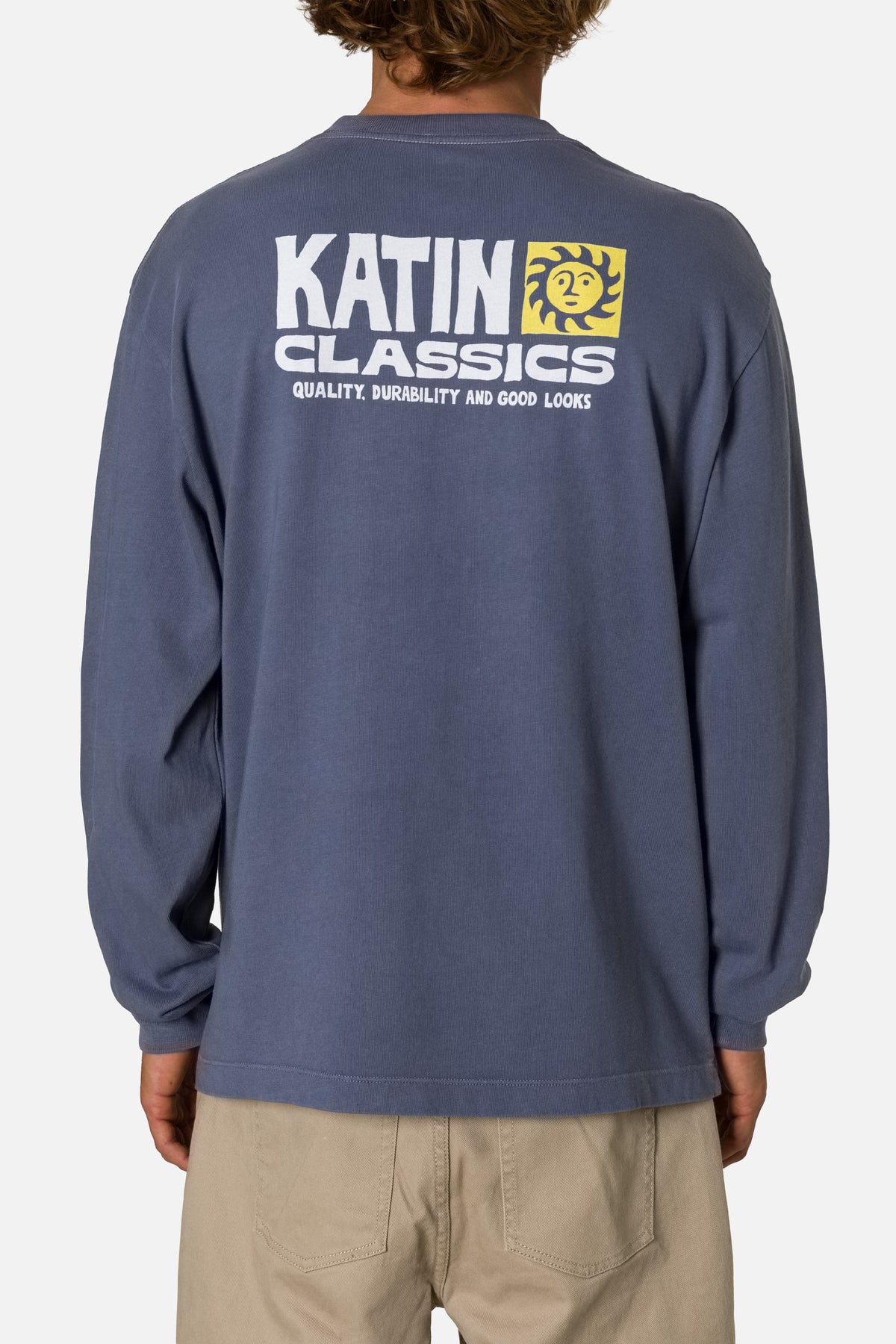 Person wearing a blue long-sleeve shirt with Katin Classics logo on the back