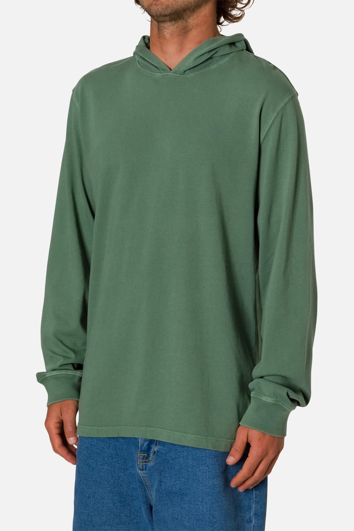 Person wearing a green hoodie and blue jeans on a white background