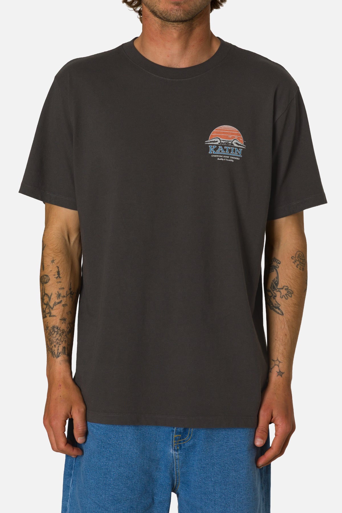 Person wearing a black t-shirt with a logo on a white background