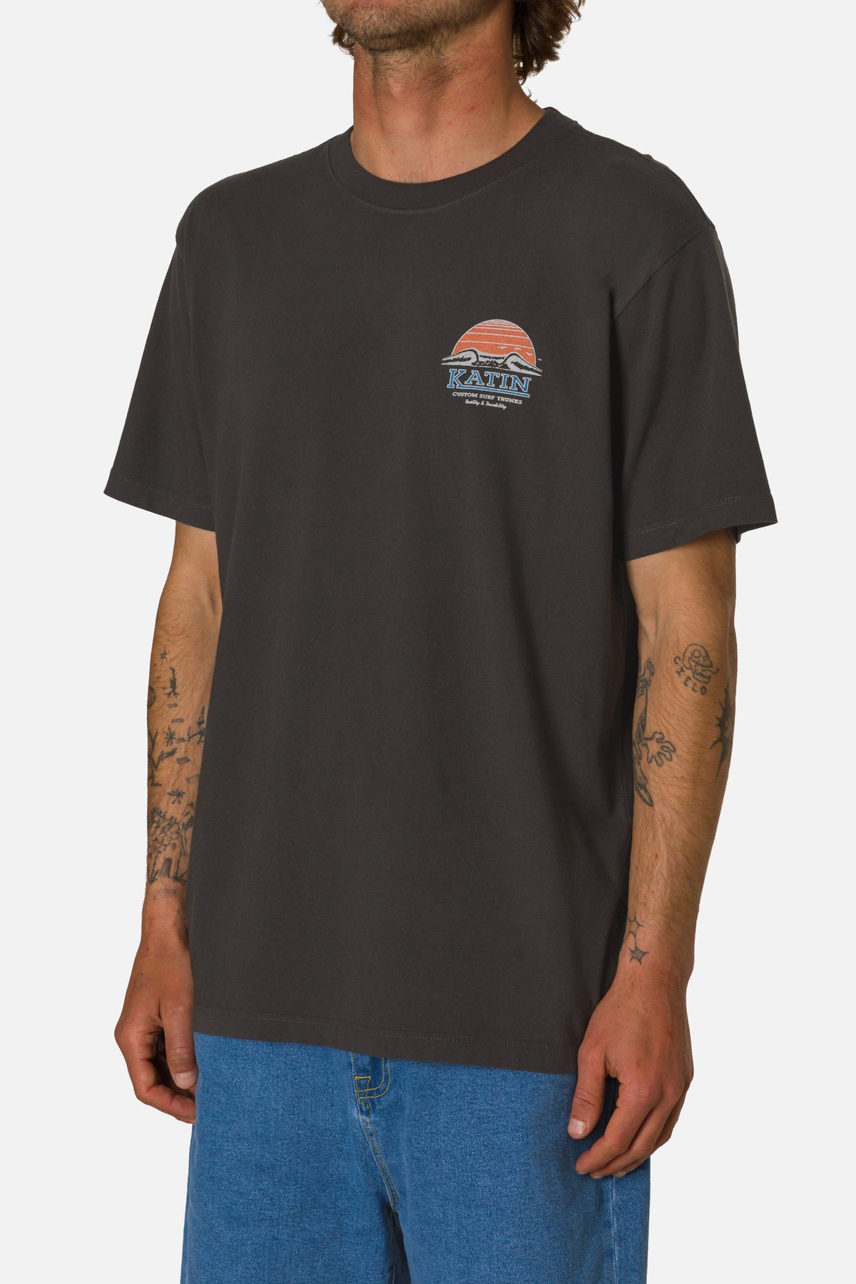 Person wearing a black t-shirt with a logo on a white background