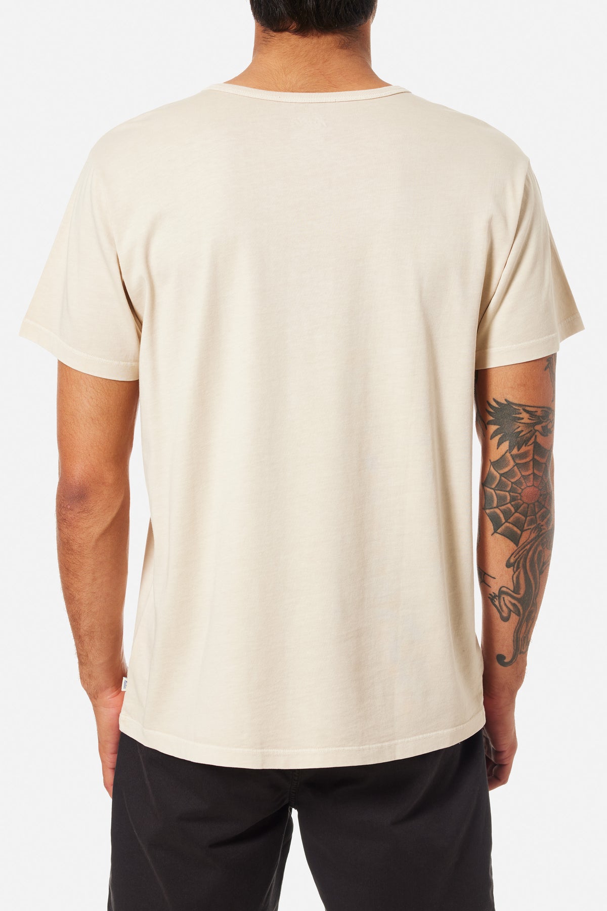 A person wearing a off white Henley shirt and blue jeans on a white background 