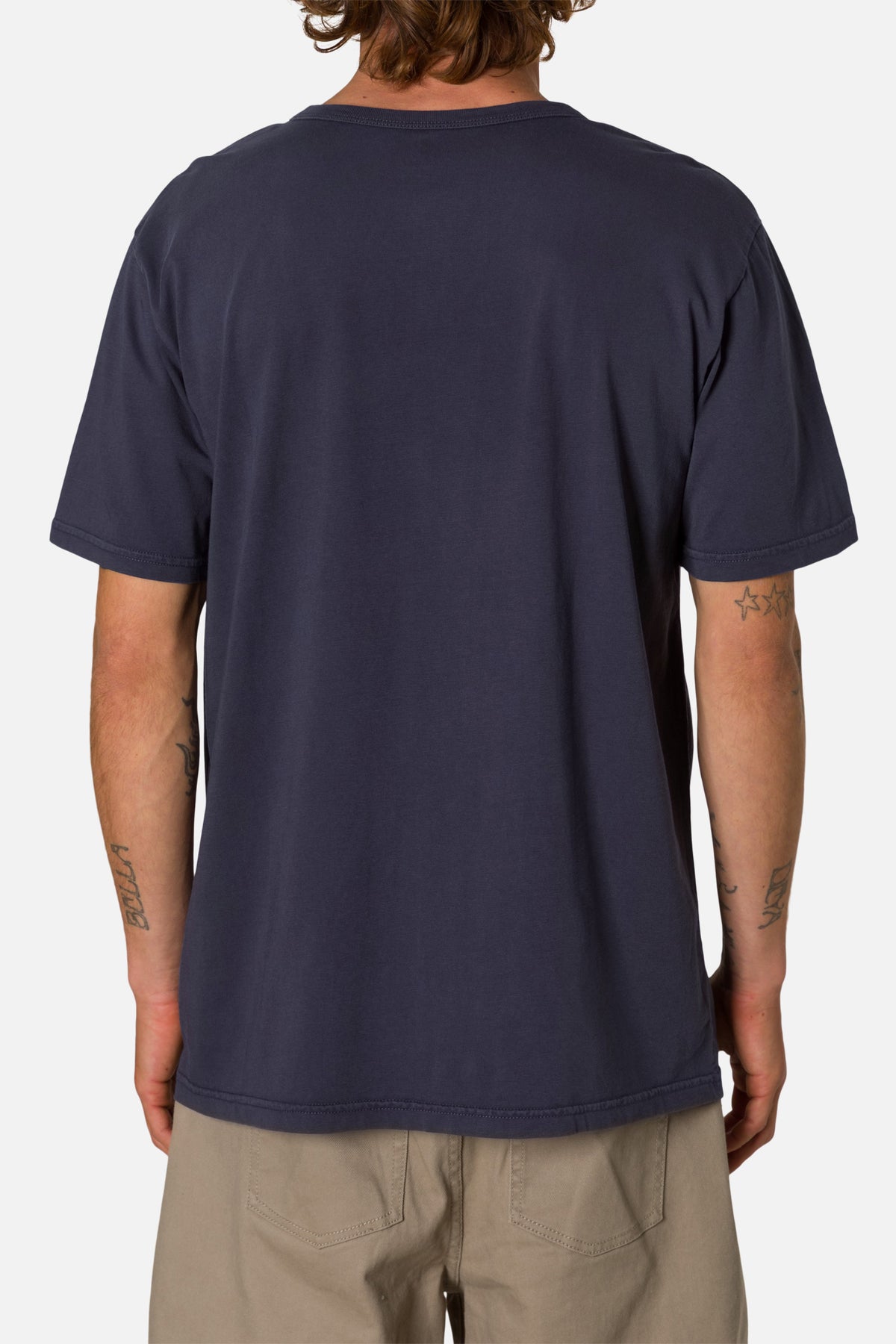 Person wearing a  navy blue henley shirt on a white background