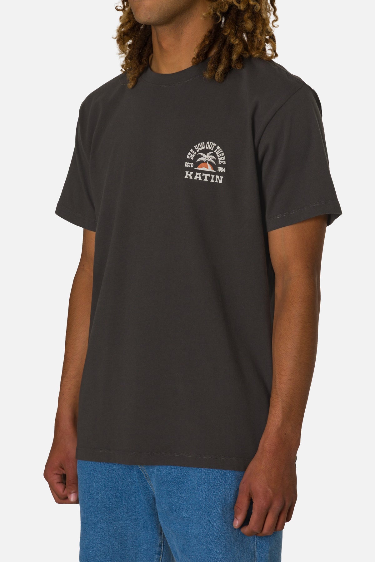 Person wearing a black t-shirt with a logo and text on a white background
