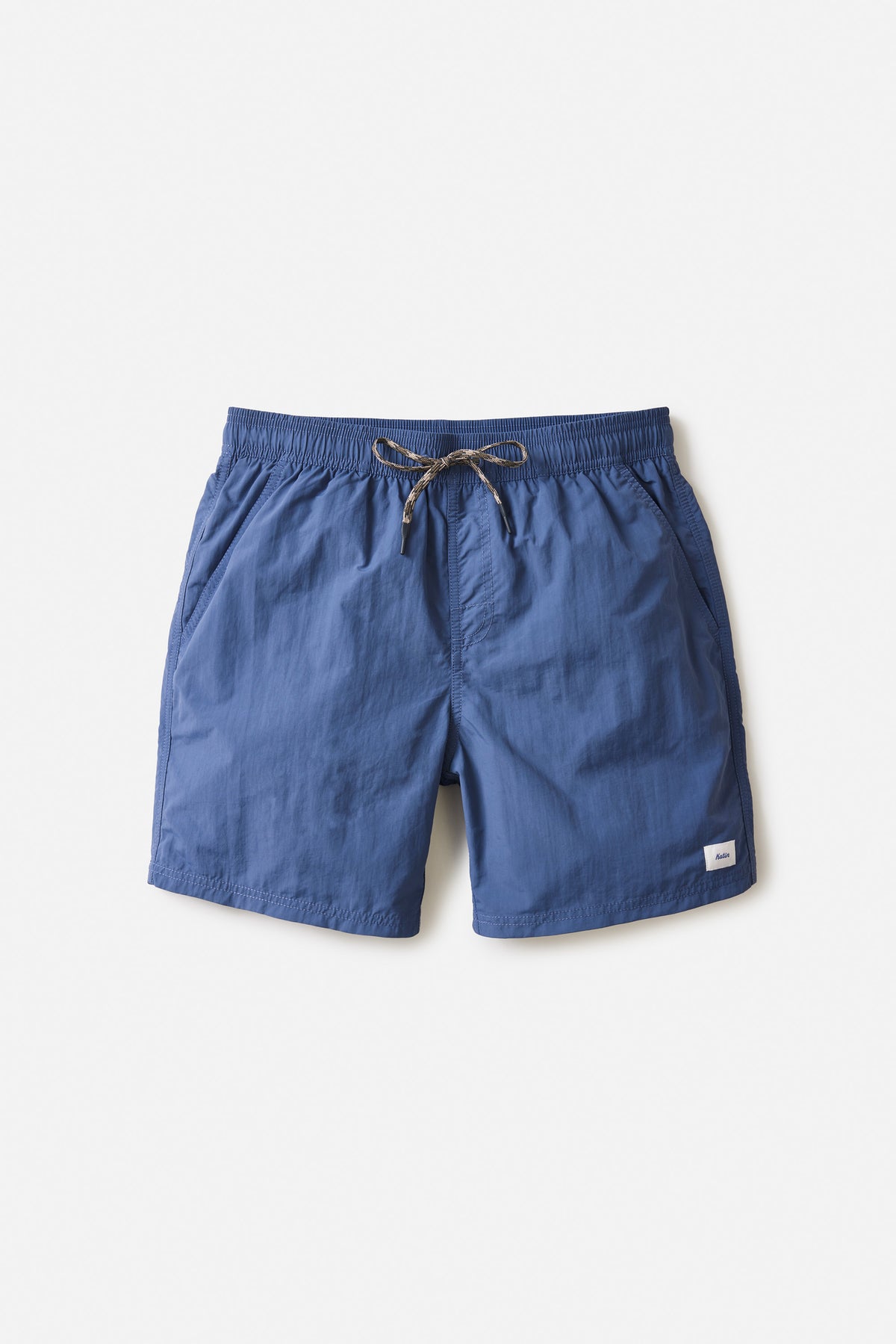 A pair of teal blue nylon volley shorts with an elastic waistband and drawstring, featuring front slash pockets and a small logo on the left leg.
