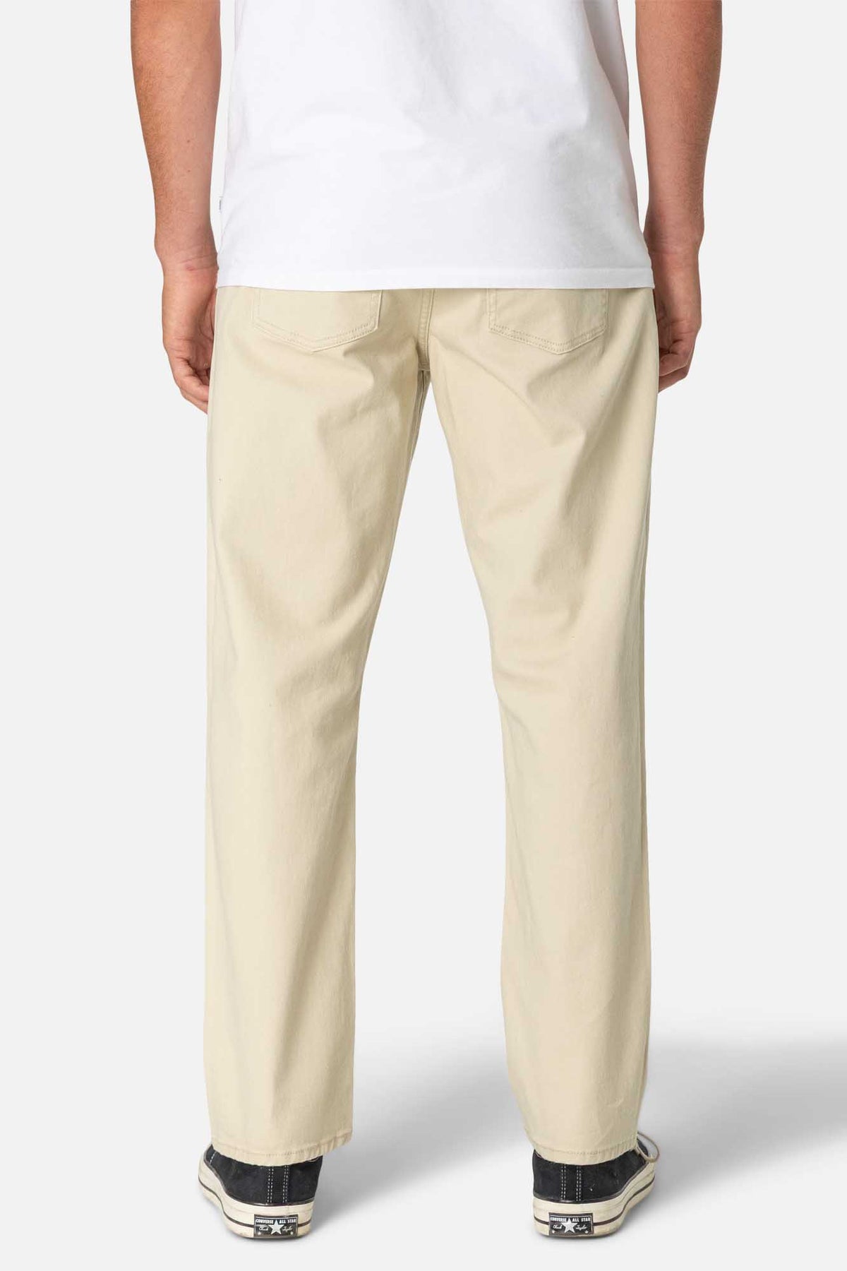 Beige pants worn by a person on a white background