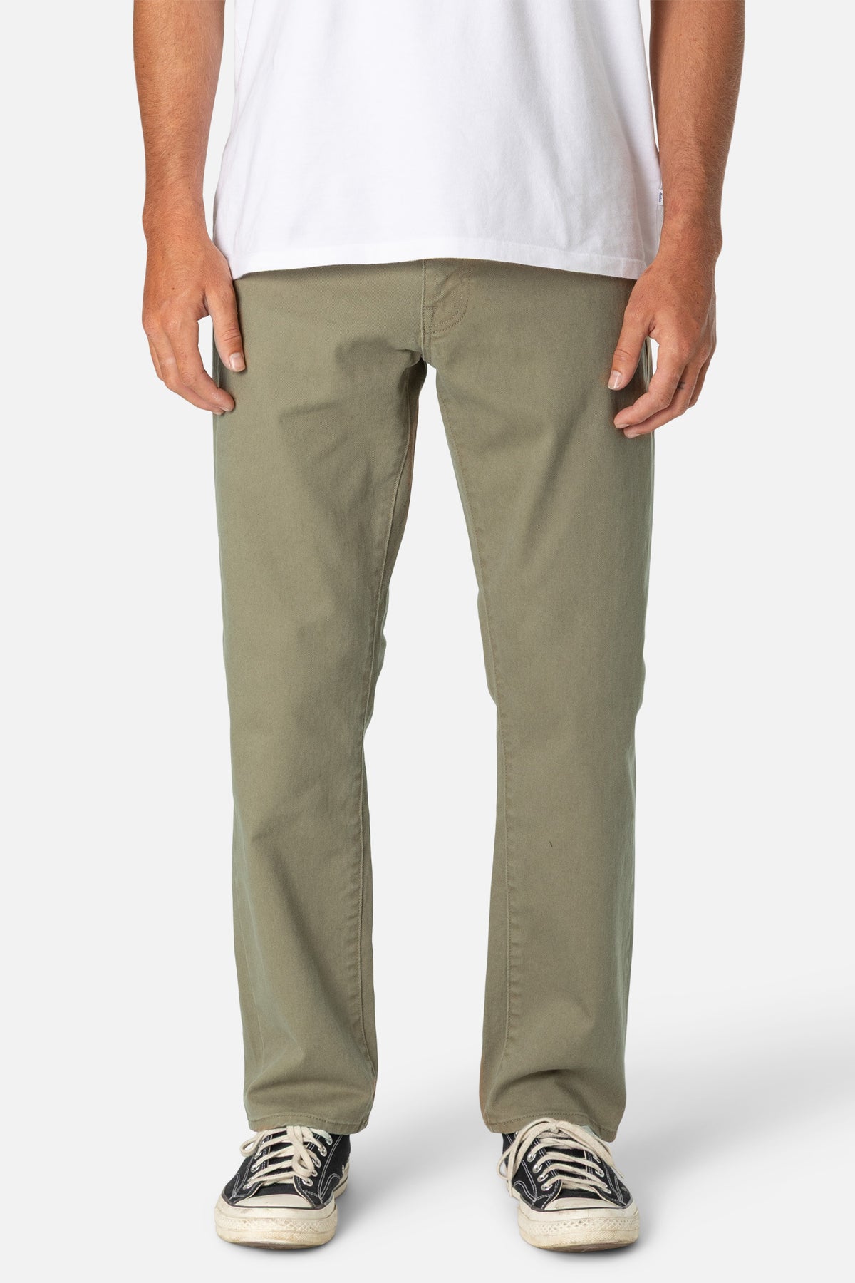 Person wearing khaki pants and a white shirt on a white background