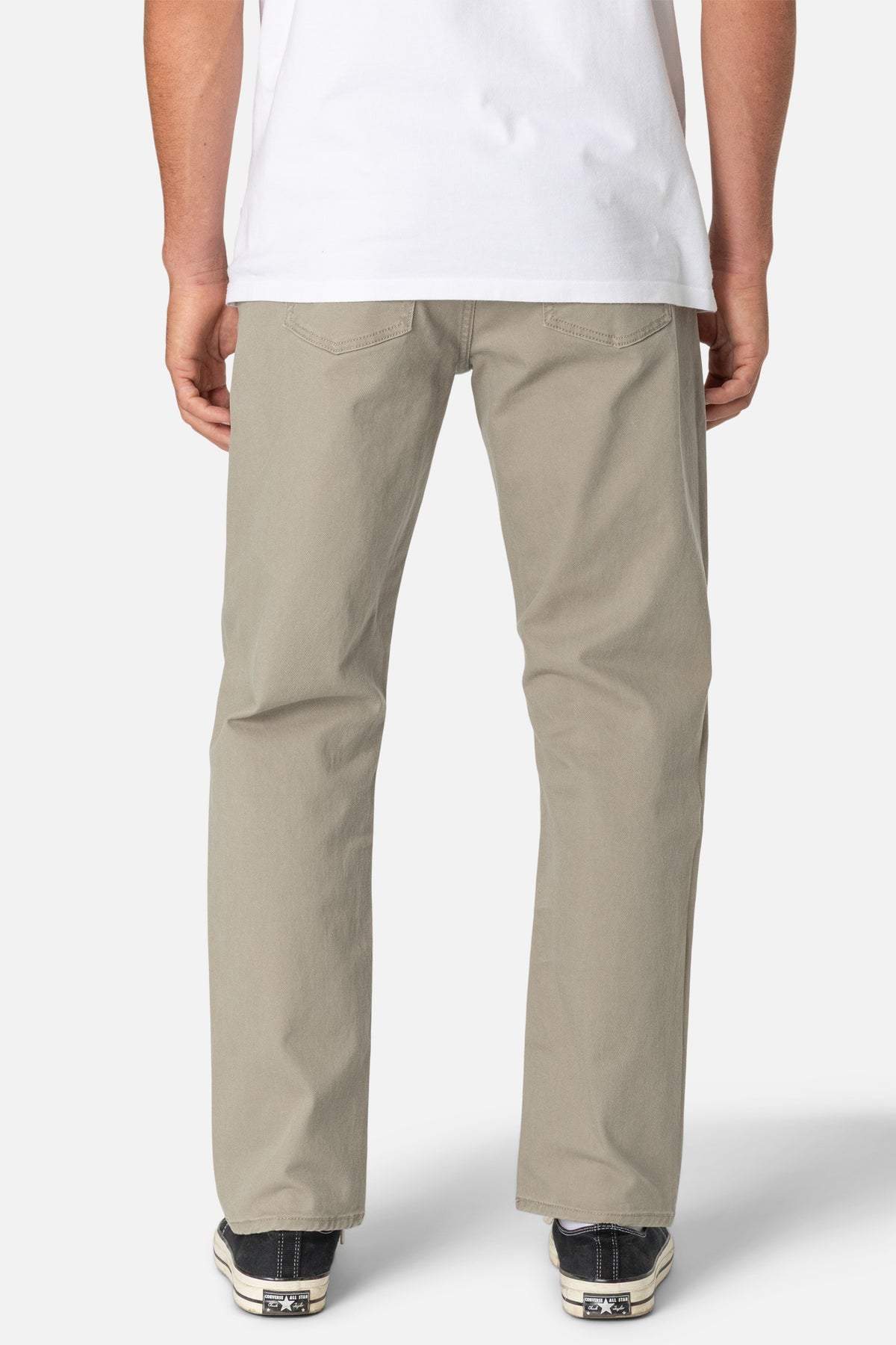 Person wearing beige pants on a white background