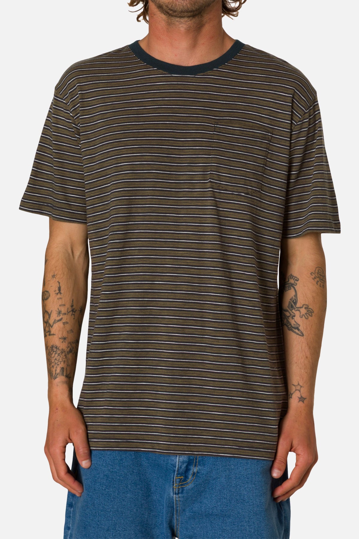 Person wearing a brown and black striped t-shirt with blue pants on a white background