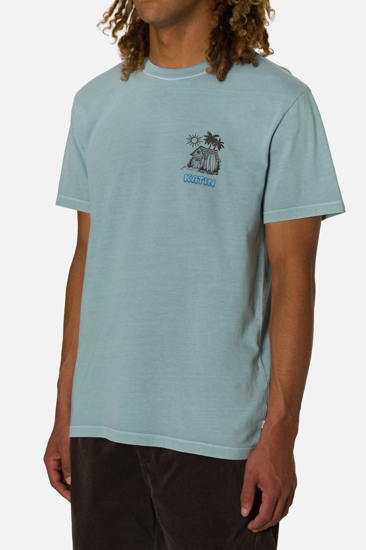 Person wearing a light blue t-shirt with a graphic design on a white background