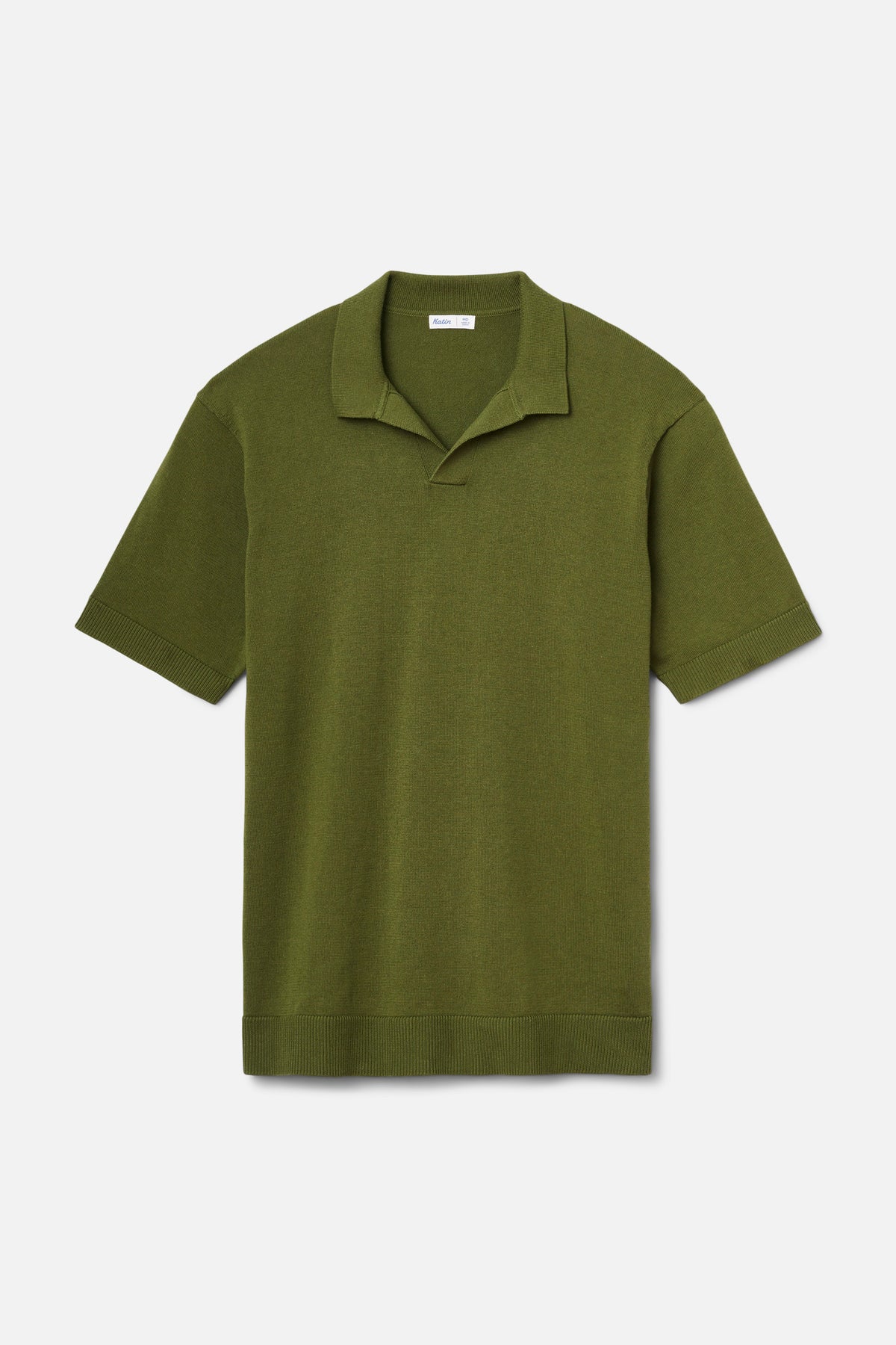 Green polo shirt on a light gray background