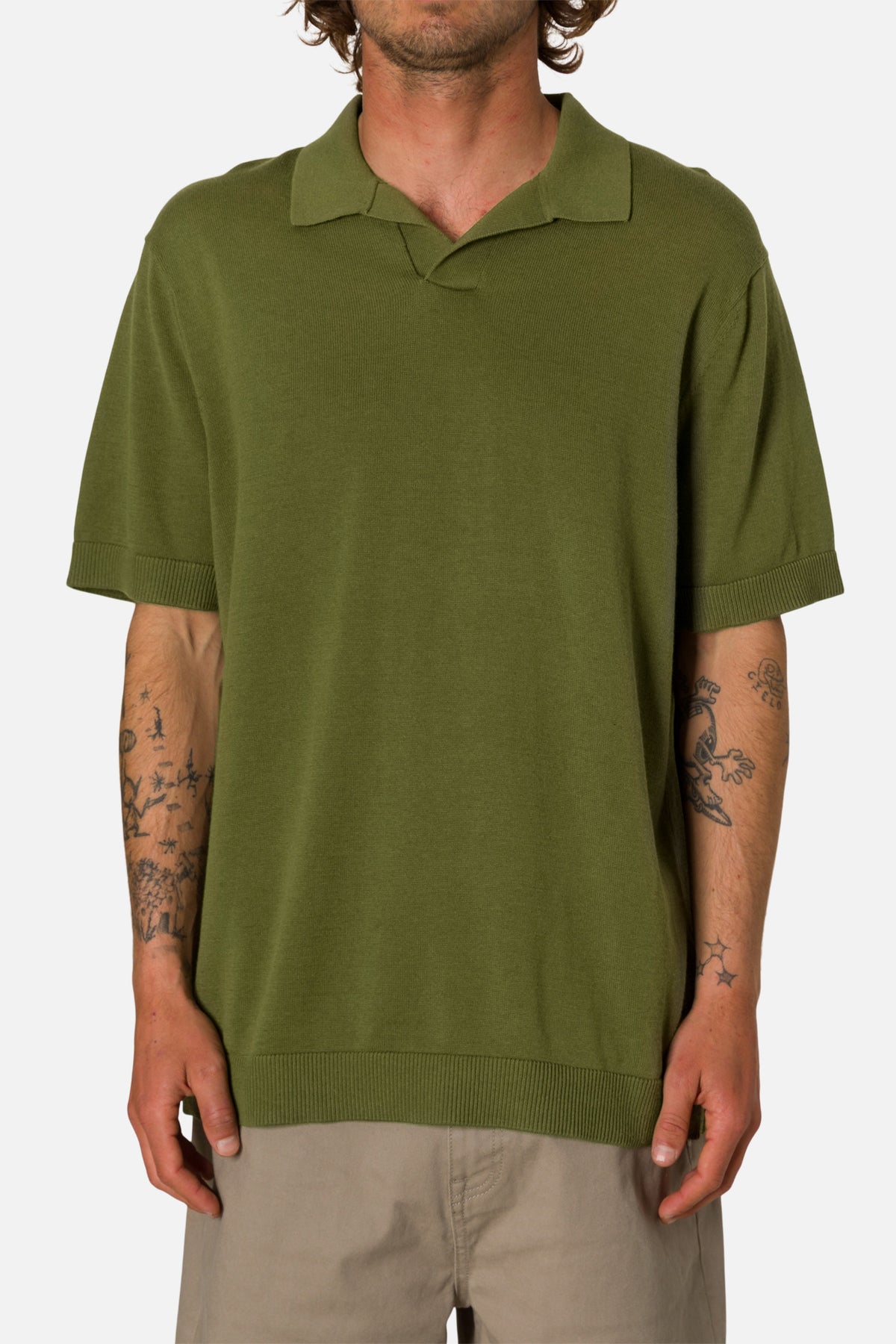 Man wearing a green polo shirt on a white background