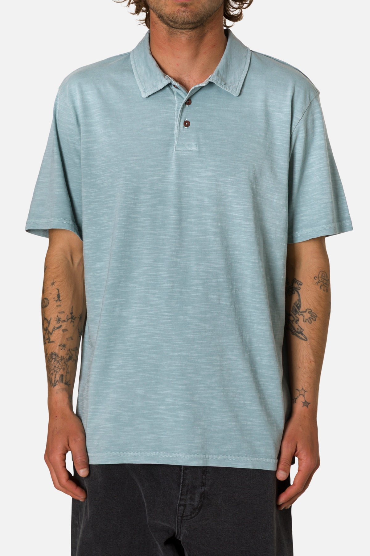 Man wearing a light blue polo shirt on a white background