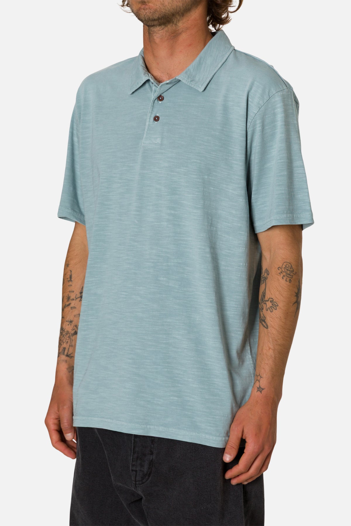 Man wearing a light blue polo shirt on a white background